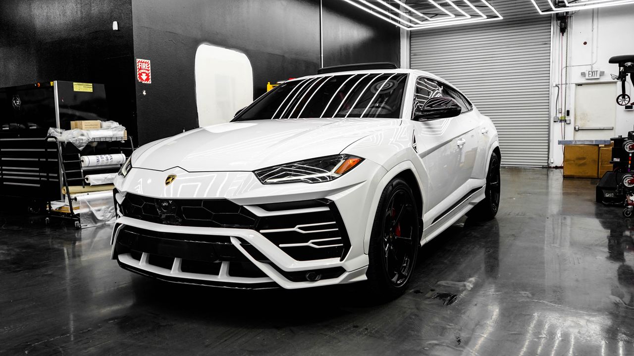 White luxury SUV in a sleek garage, showcasing modern design and premium automotive style.